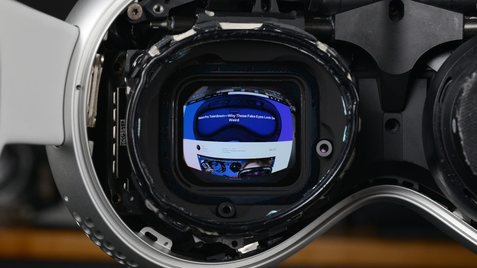 A computer monitor is seen through the eyepiece of an Apple Vision Pro headset.