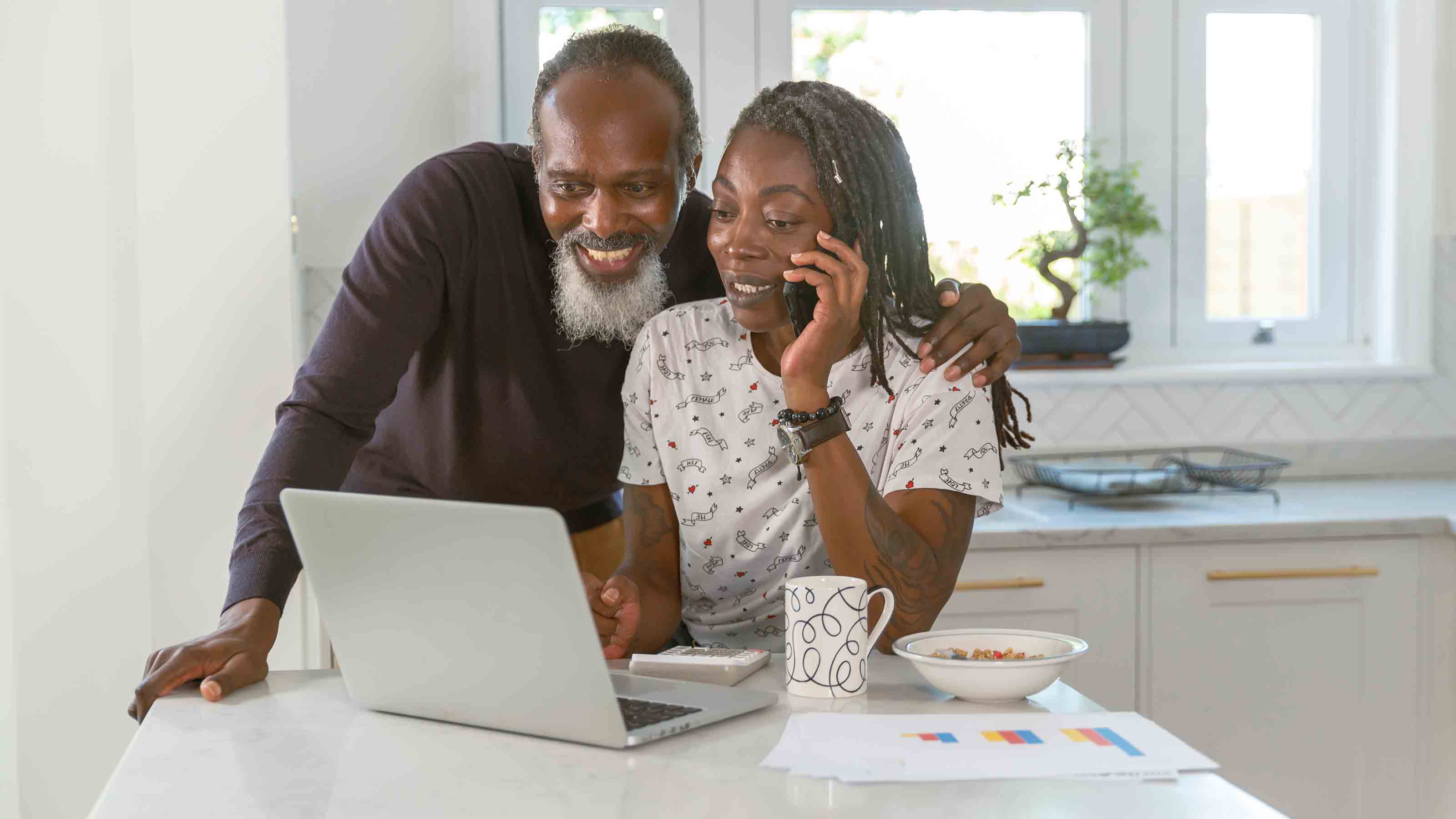 Senior couple budgeting personal finances and paying bills online