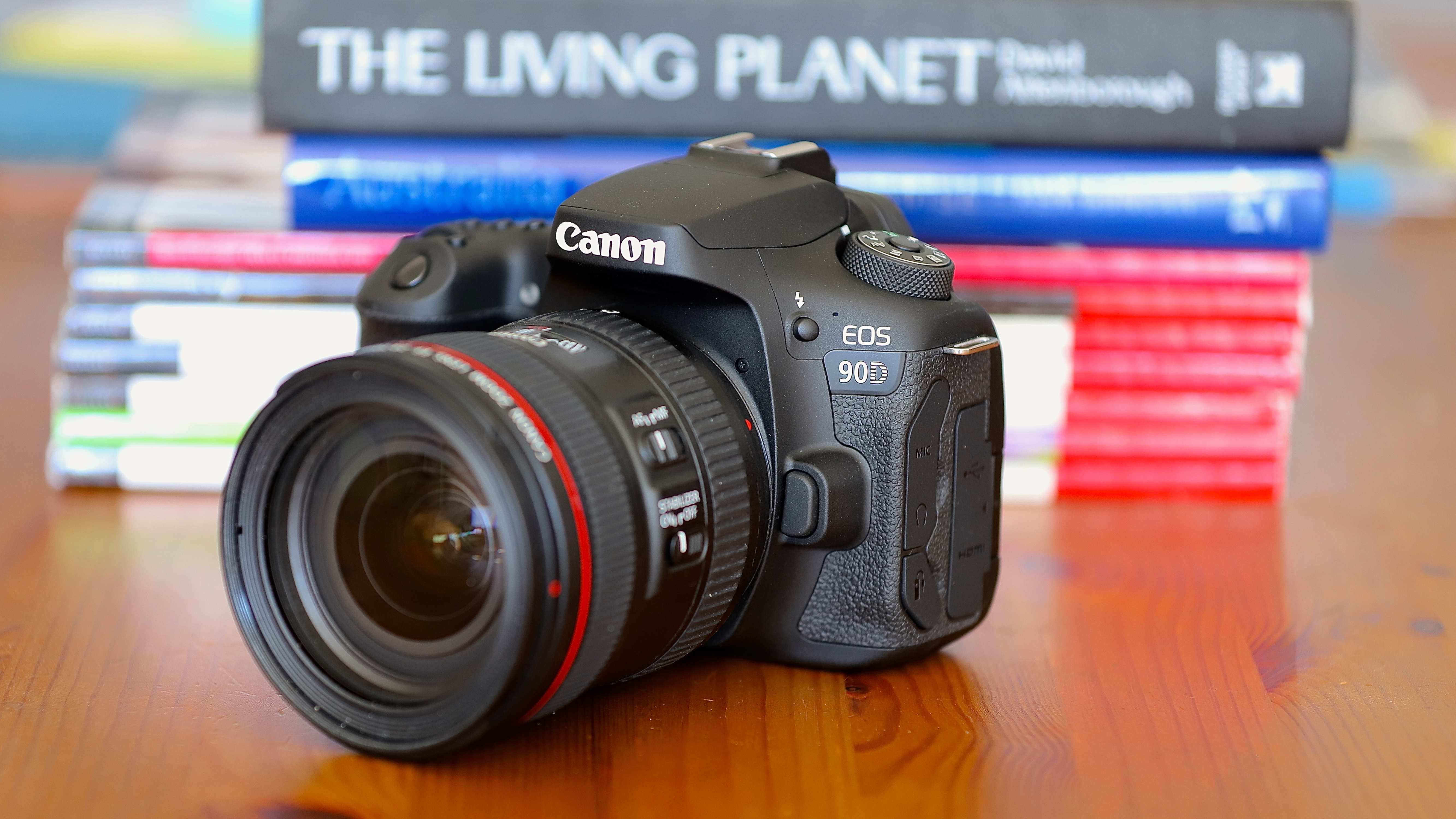 Canon EOS 90D camera on a wooden table