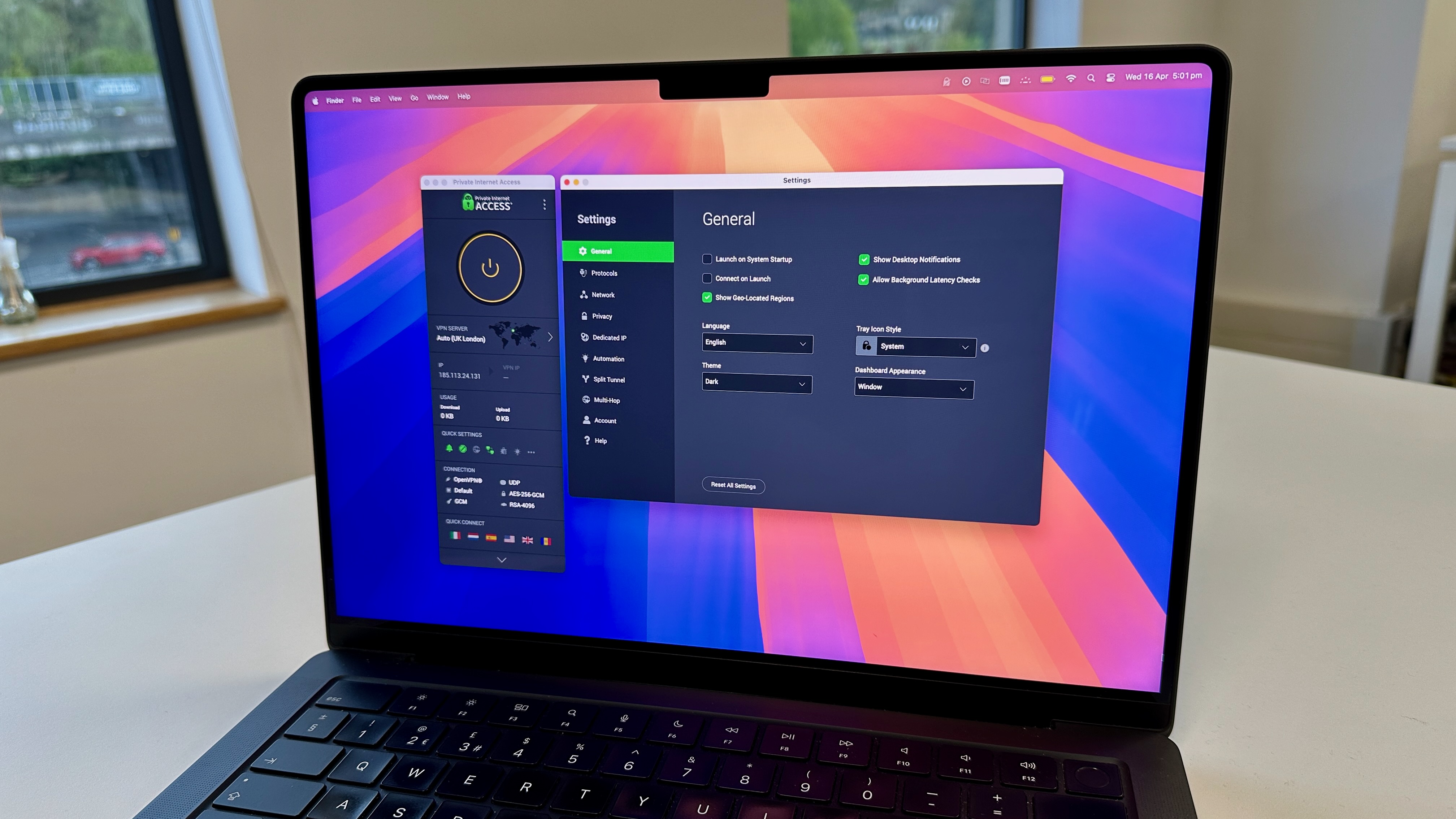 PIA's homepage on its macOS app. On the right is a widget showing that PIA is connected, as well as its speed, quick settings and connection settings. On the left is a window for PIA's general settings, including launch on system startup, show desktop notifications, connect on launch, allow background latency checks and show geo-located regions. There are also settings for language, tray icon style, theme and dashboard appearance. There is also a button to reset all settings.