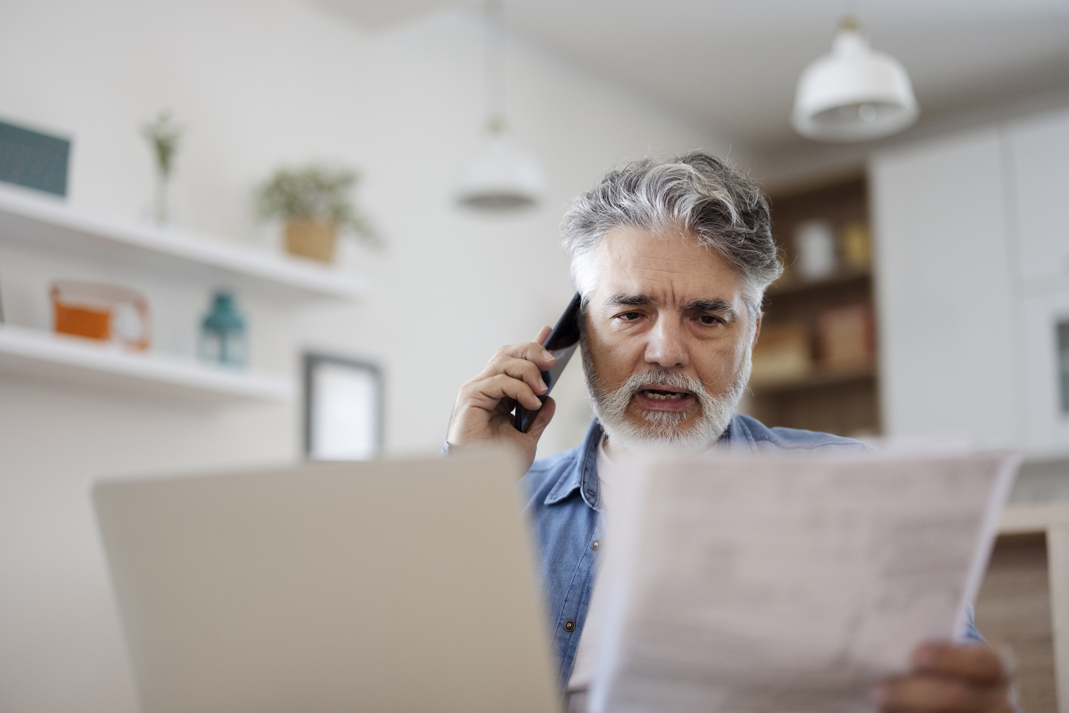 A man is talking on his phone discussing his phone plan.