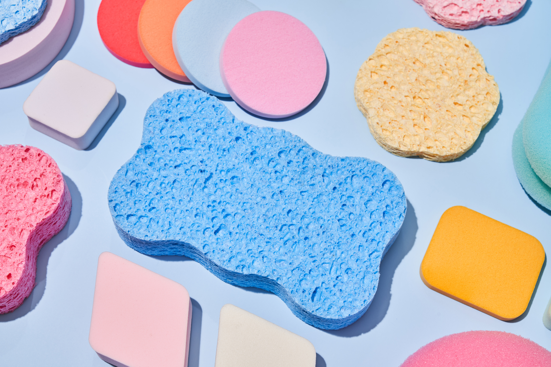 spring cleaning concept with sponges of different shapes and assorted colors