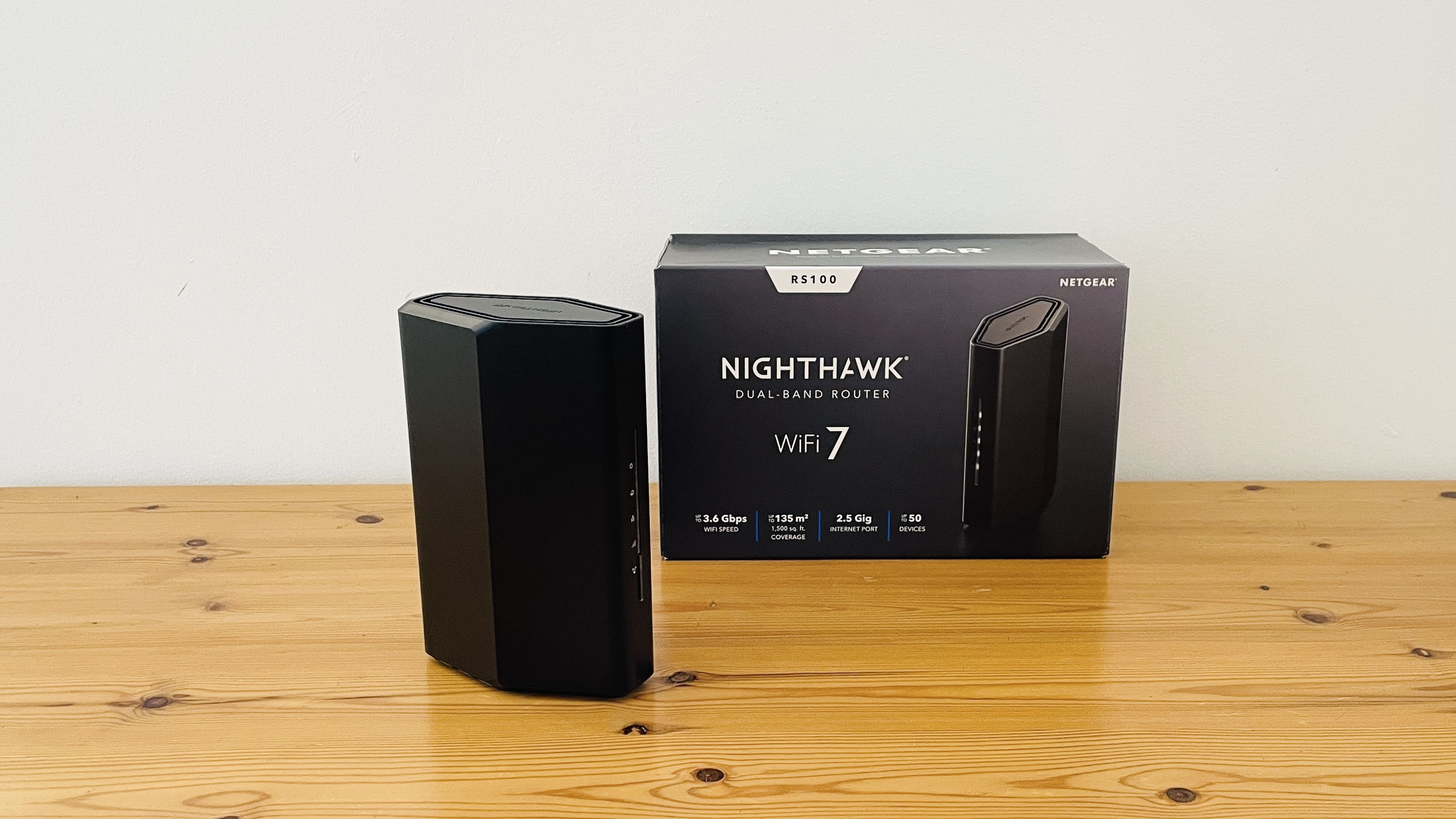 Netgear Nighthawk RS100 router on wooden table