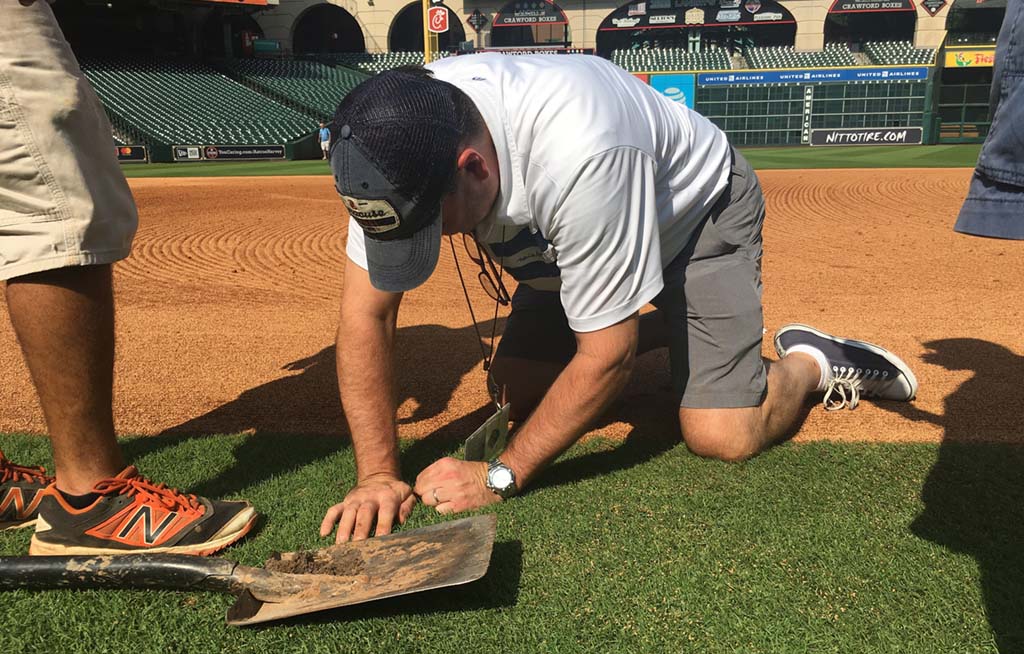 Joseph Carpenter, audio mixer for Fox Sports, sets up field mics at Daiken Park, home of the Houston Astros MLB team. 